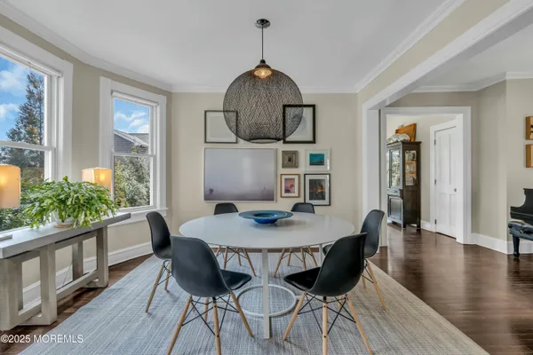 a dining room with furniture a window and wooden floor