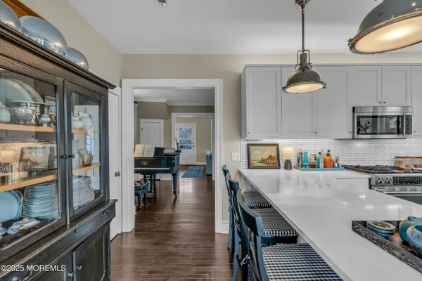 a kitchen with kitchen island granite countertop lots of counter top space a sink and appliances