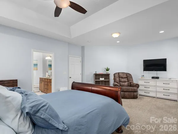a spacious bedroom with a bed and a table in it