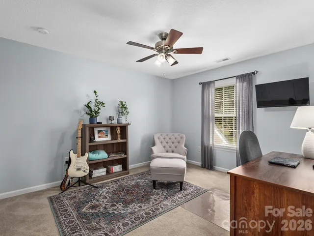 a bedroom with a bed and a table with chair