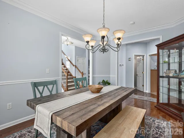a bed room with a bed and a chandelier