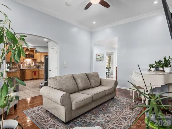a kitchen with stainless steel appliances granite countertop white cabinets a sink and a stove
