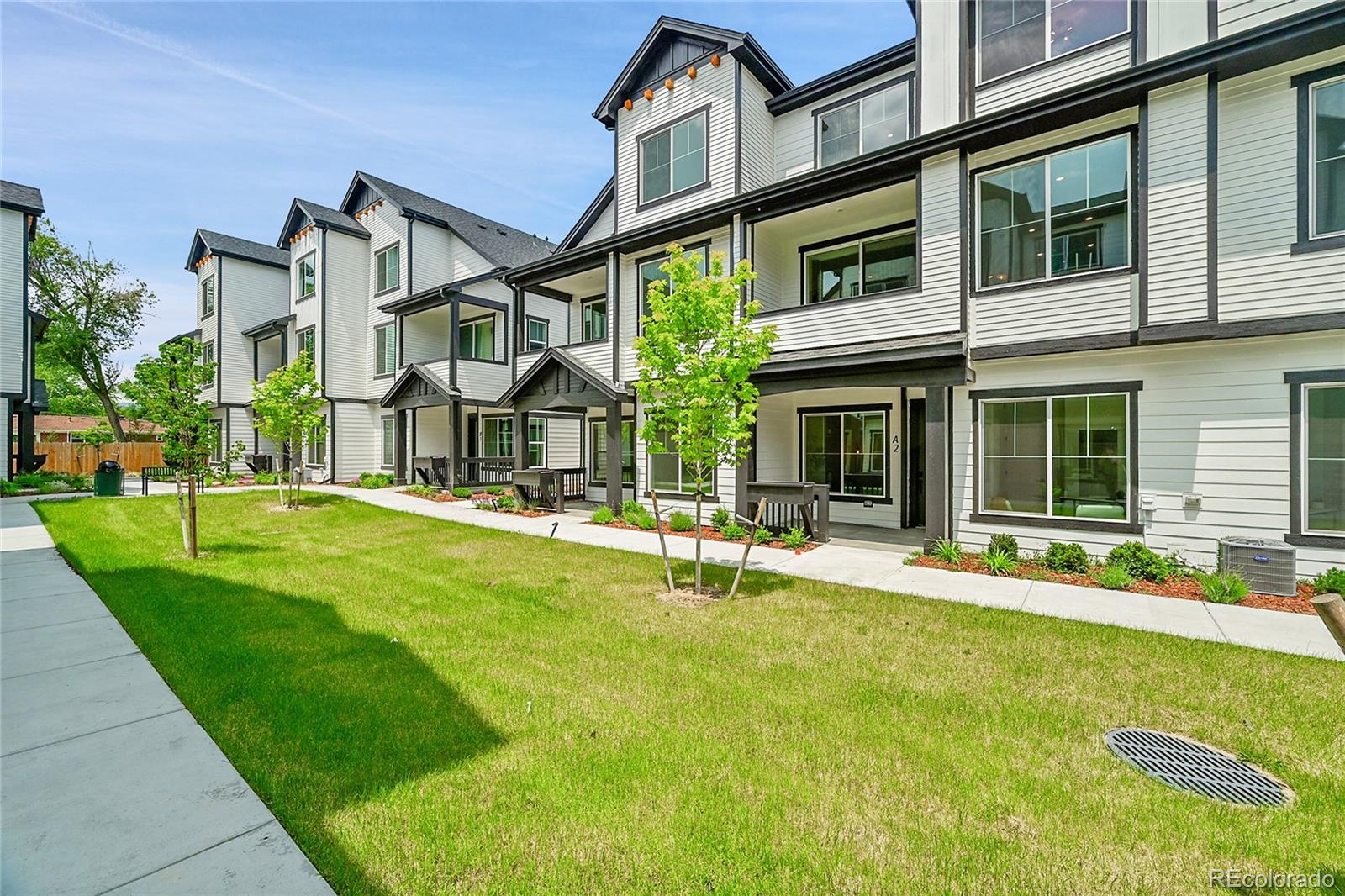 front view of a house with a yard and porch