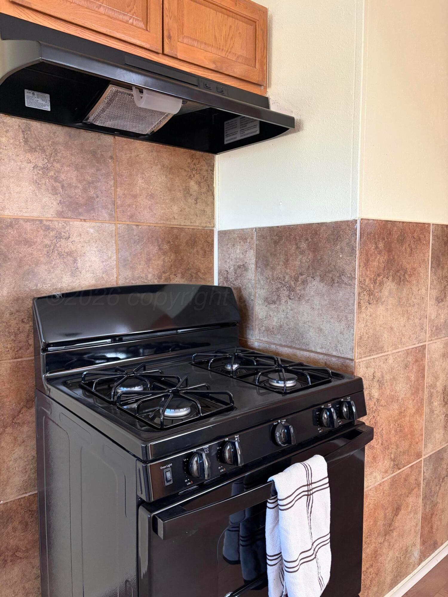 1012 Harper Street Amarillo, TX 79107 - Photo 7 of 24 a stove top oven sitting inside of a kitchen