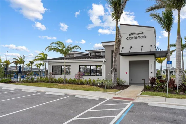 a view of a house with pool and outdoor seating