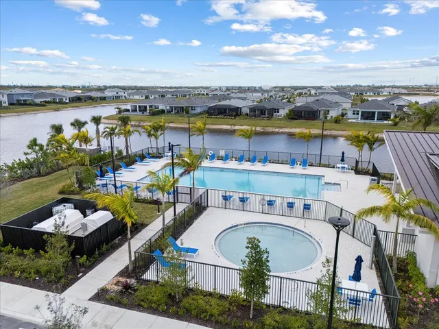a view of a swimming pool with outdoor seating