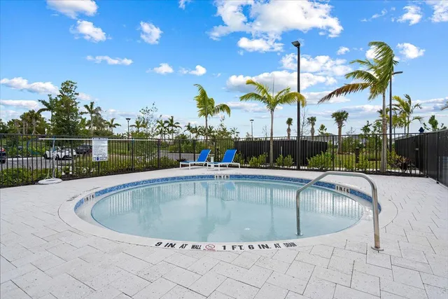 a view of a swimming pool with an outdoor seating