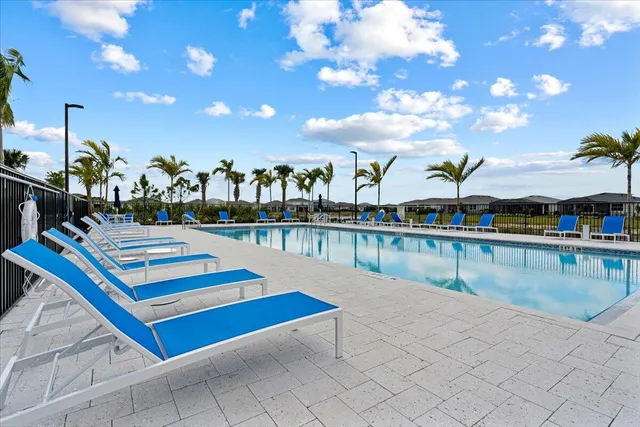 a swimming pool with outdoor seating and yard