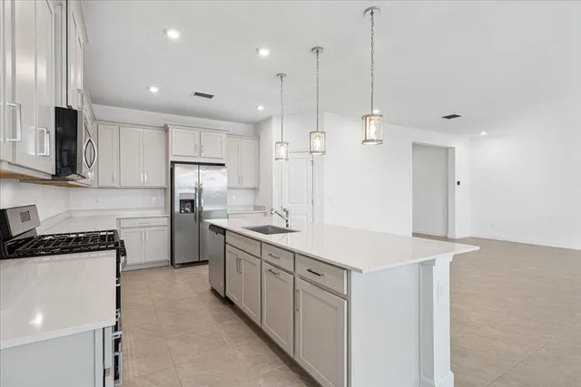 a kitchen that has a lot of cabinets and wooden floor