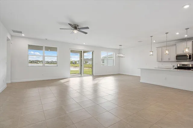 a view of an empty room with window and cabinet