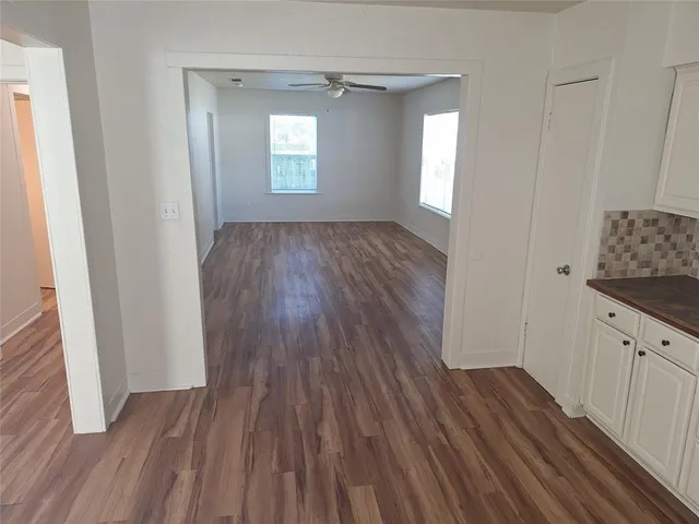 wooden floor in an empty room with a mirror