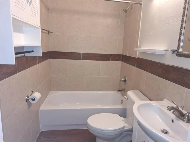 a bathroom with a toilet a sink and bathtub