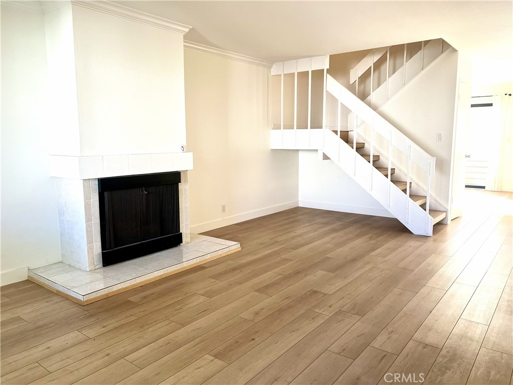 4 Latitude Court Newport Beach, CA 92663 - Photo 11 of 41 a view of an empty room with wooden floor and a fireplace