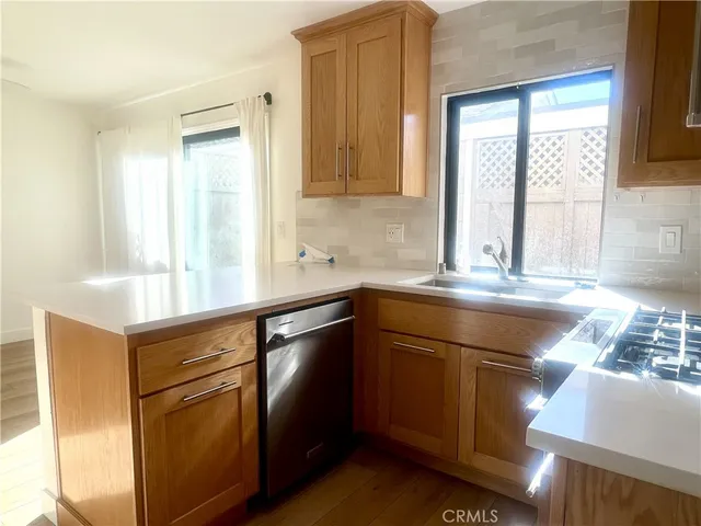 a kitchen with stainless steel appliances granite countertop a sink and a stove top oven