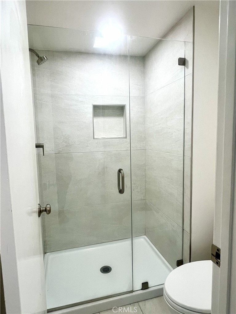 4 Latitude Court Newport Beach, CA 92663 - Photo 25 of 41 a bathroom with a shower and toilet