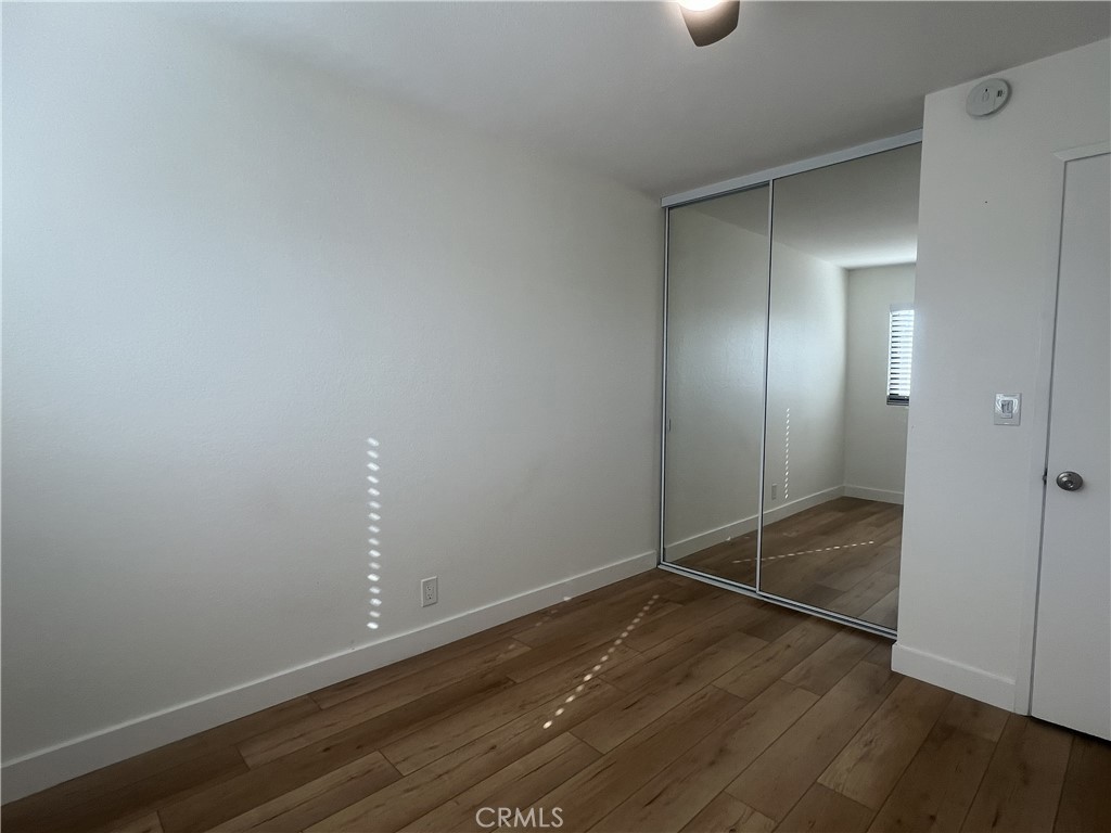 4 Latitude Court Newport Beach, CA 92663 - Photo 27 of 41 a view of an empty room with wooden floor