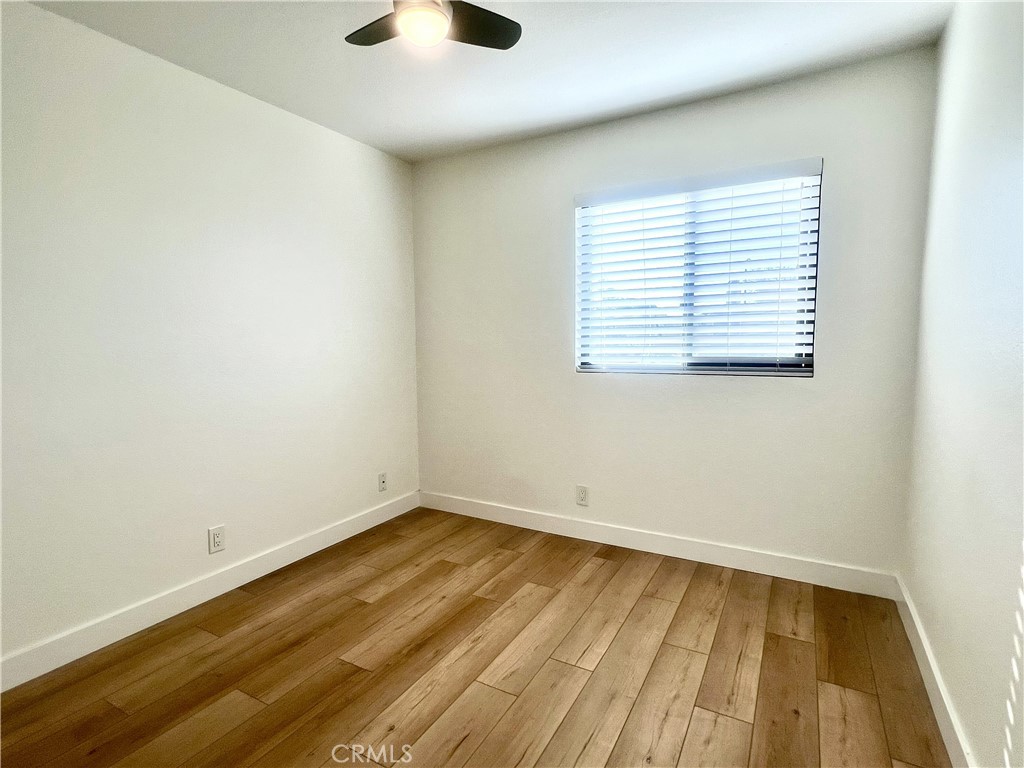 4 Latitude Court Newport Beach, CA 92663 - Photo 30 of 41 an empty room with wooden floor and windows