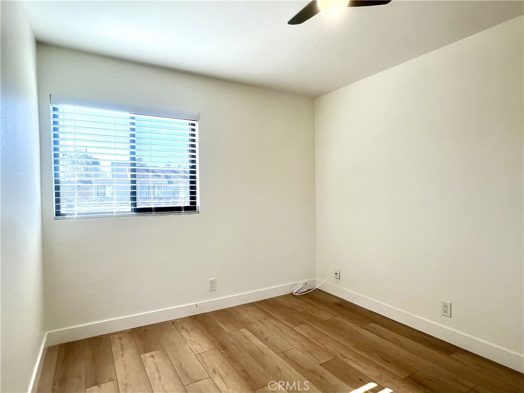 4 Latitude Court Newport Beach, CA 92663 - Photo 31 of 41 an empty room with wooden floor and windows