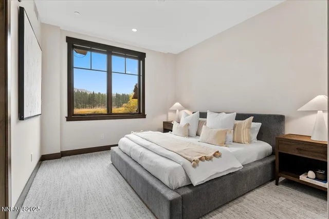 a bedroom with a large bed and a window