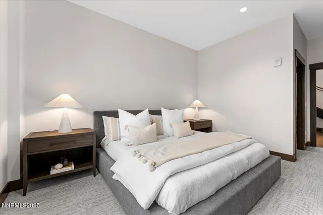 a bedroom with a bed and a lamp on table