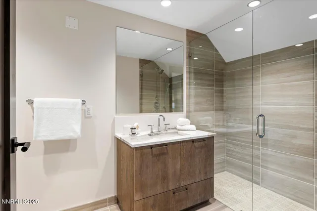 a bathroom with a sink shower and a mirror