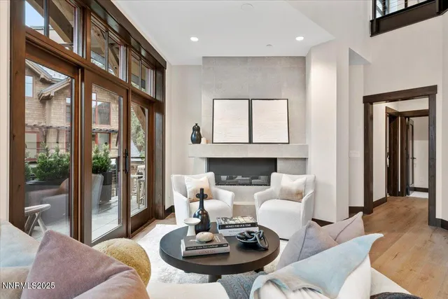 a living room with furniture fireplace and a large window