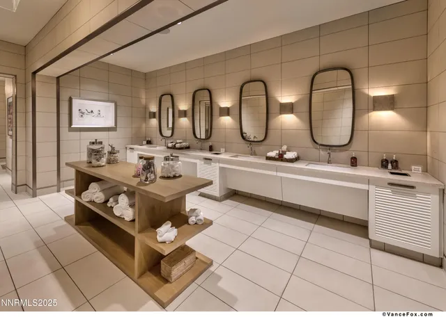 a bathroom with a double vanity sink mirror and bathtub