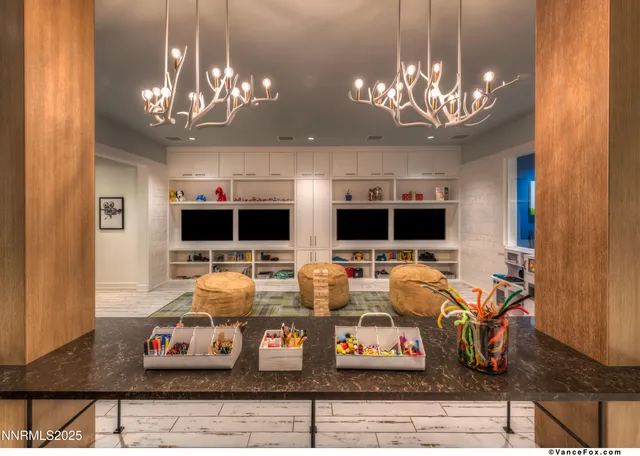 a view of a dining room with furniture a chandelier and wooden floor