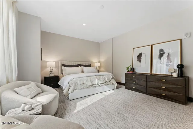 a bedroom with a bed and a mirror on dresser