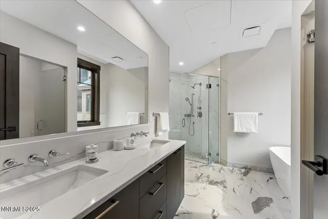 a bathroom with a sink double vanity and a shower