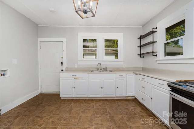 a spacious bathroom with a granite countertop sink mirror and window