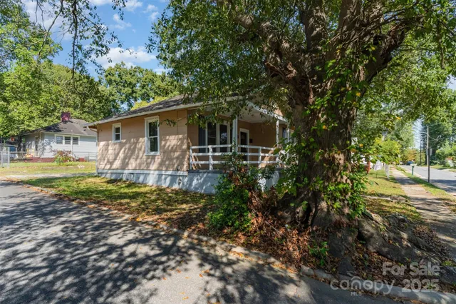 a backyard of a house with barbeque oven table and chairs