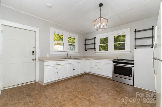 a kitchen that has a stove and a window