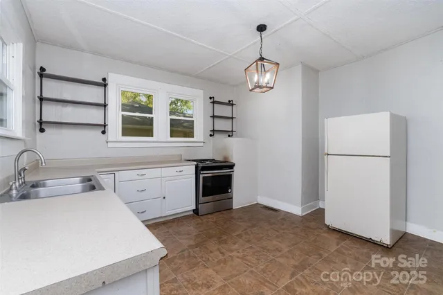 a kitchen with a refrigerator a sink and dishwasher