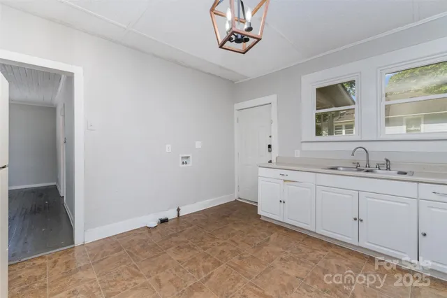 a spacious bathroom with a sink and a window