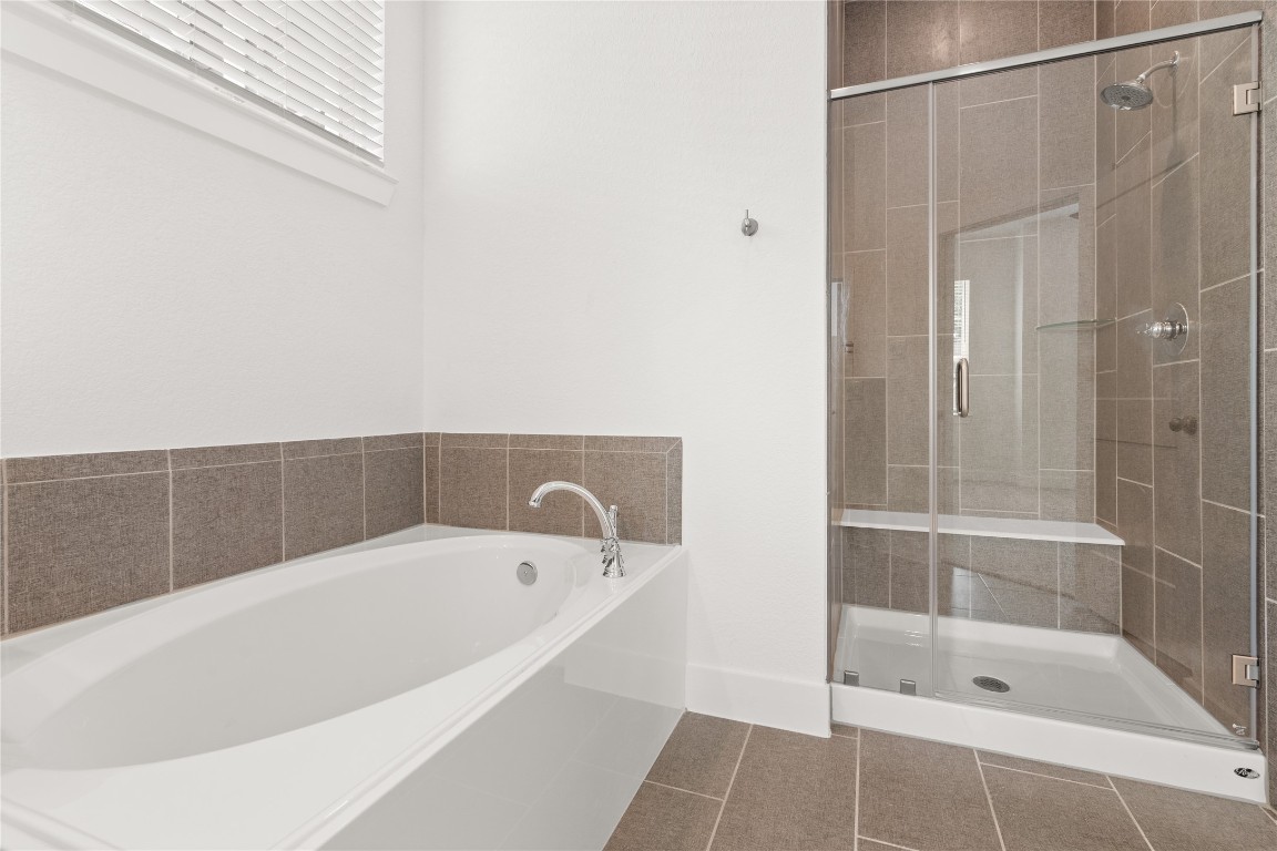 520 Red Cascade Trail Willis, TX 77318 - Photo 11 of 27 a bathroom with a bathtub and shower