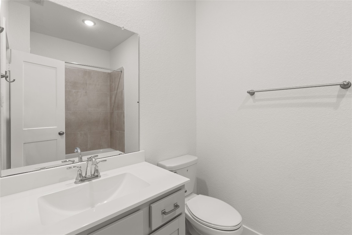 520 Red Cascade Trail Willis, TX 77318 - Photo 14 of 27 a bathroom with a sink a toilet and vanity