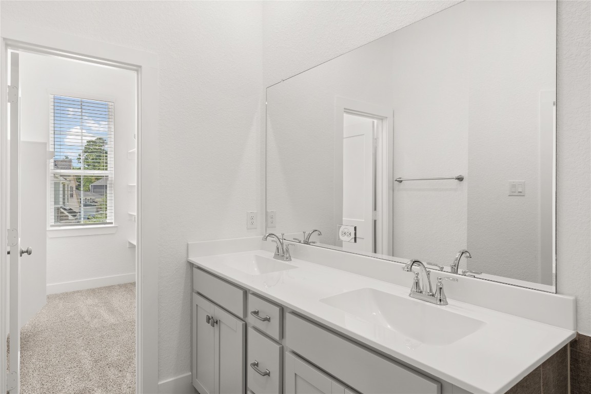 520 Red Cascade Trail Willis, TX 77318 - Photo 9 of 27 a bathroom with a sink vanity and a mirror