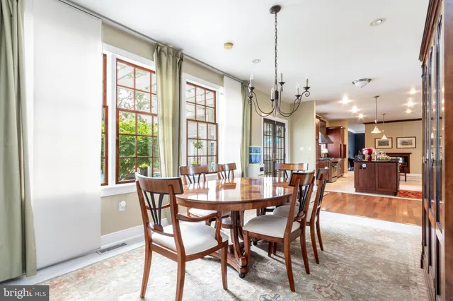 a dining room with furniture a chandelier and window