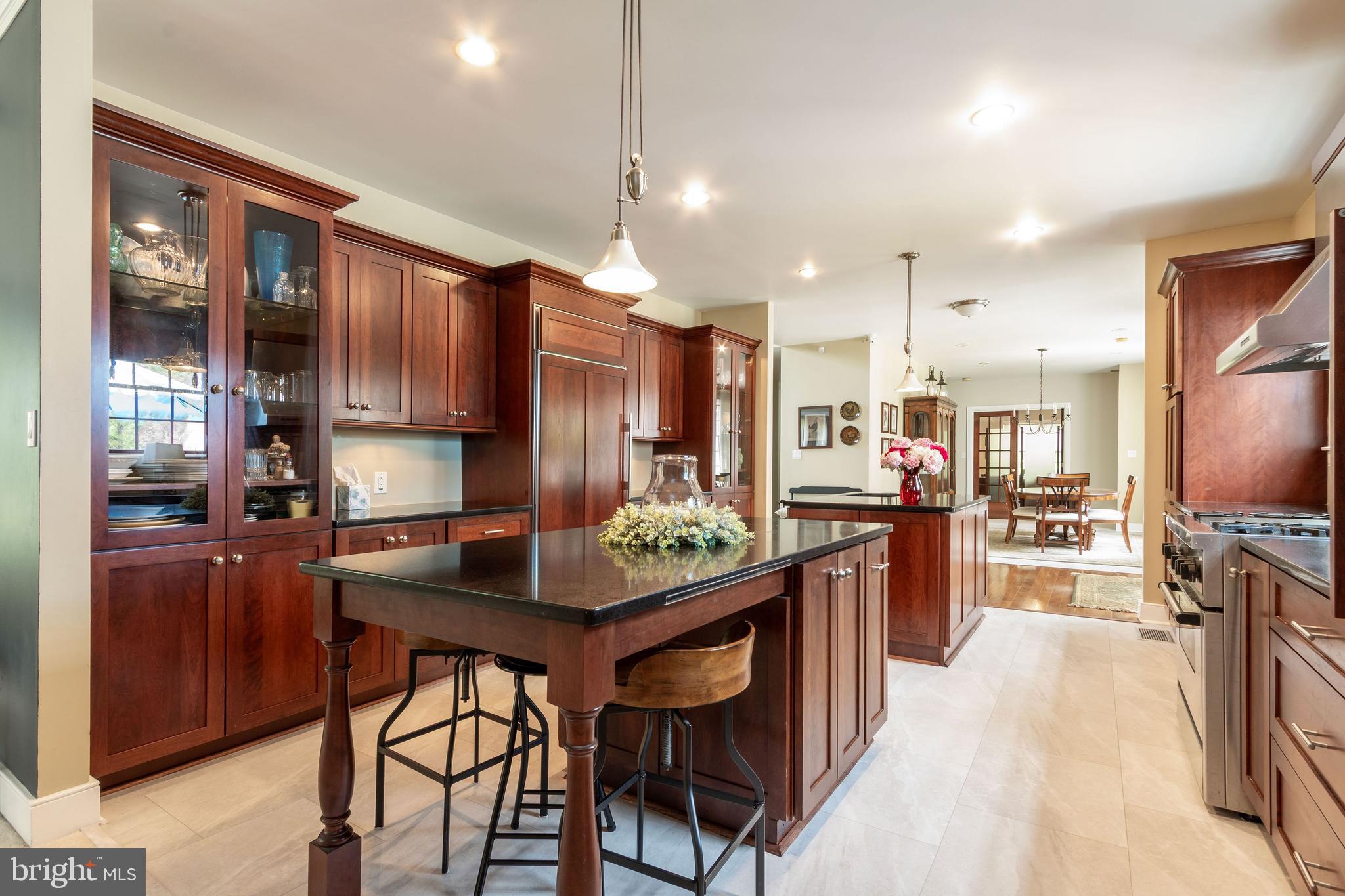 80 Linvale Road Ringoes, NJ 08551 - Photo 15 of 47 a kitchen with stainless steel appliances kitchen island granite countertop a table chairs in it and wooden floors