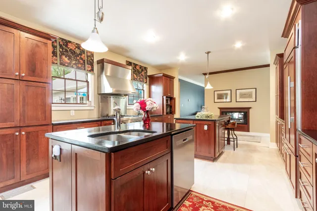 a kitchen with stainless steel appliances granite countertop sink stove and refrigerator