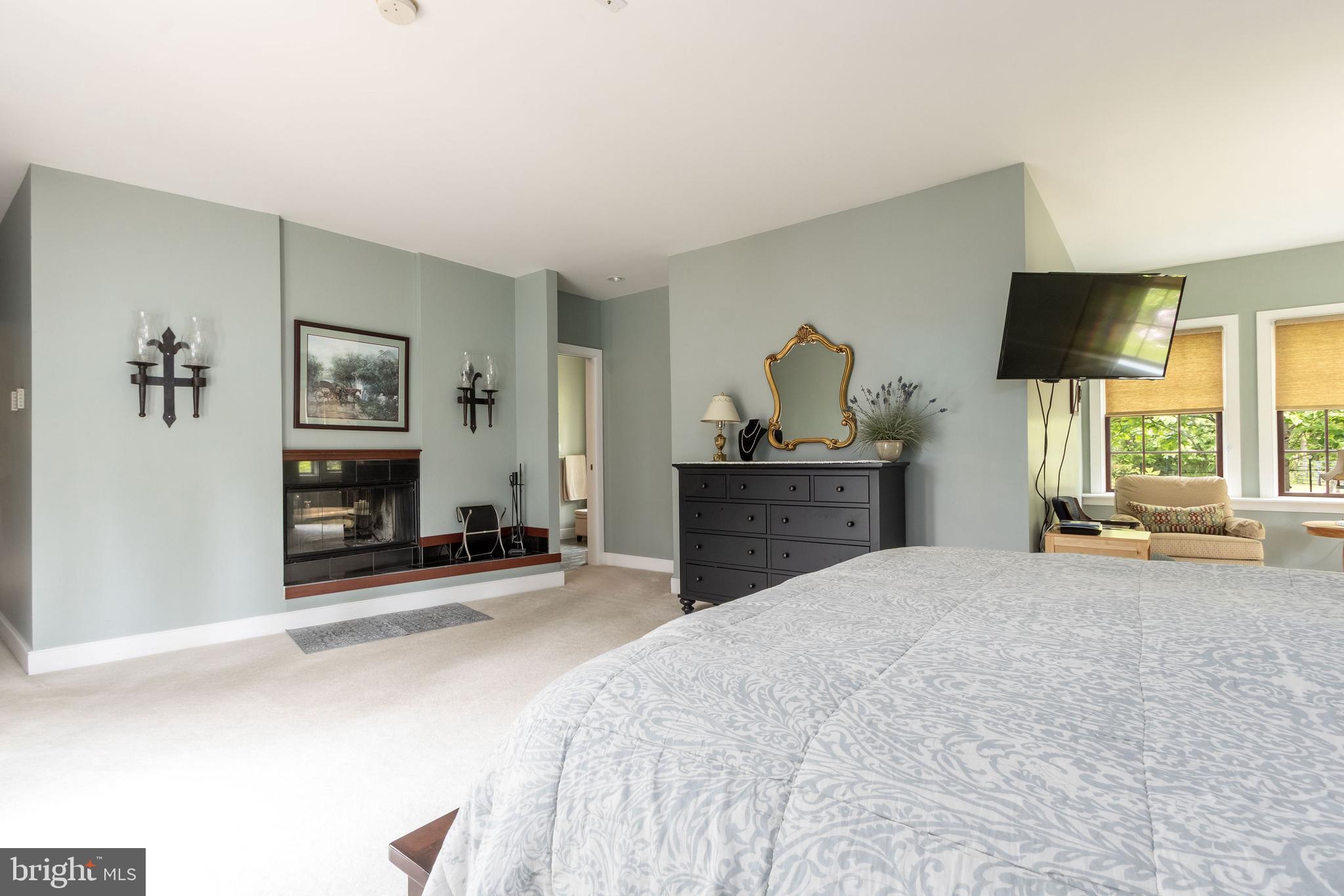 80 Linvale Road Ringoes, NJ 08551 - Photo 24 of 47 a bedroom with a bed and a flat screen tv