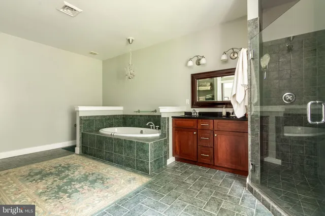 a bathroom with a sink a bathtub and a shower