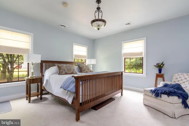 a bed sitting in a bedroom next to a window