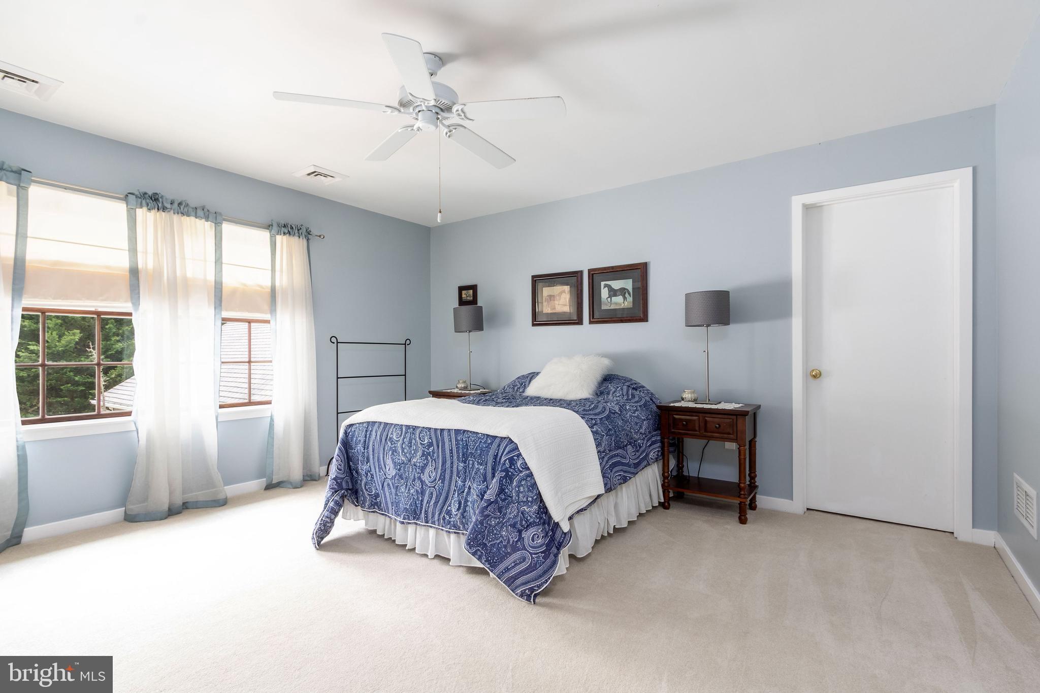 80 Linvale Road Ringoes, NJ 08551 - Photo 29 of 47 a spacious bedroom with a large bed and a chandelier