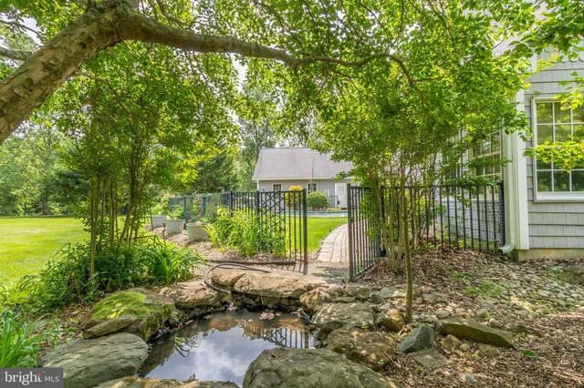 a view of house with backyard and garden