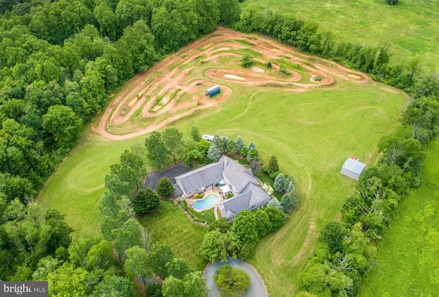 a view of a swimming pool with a yard