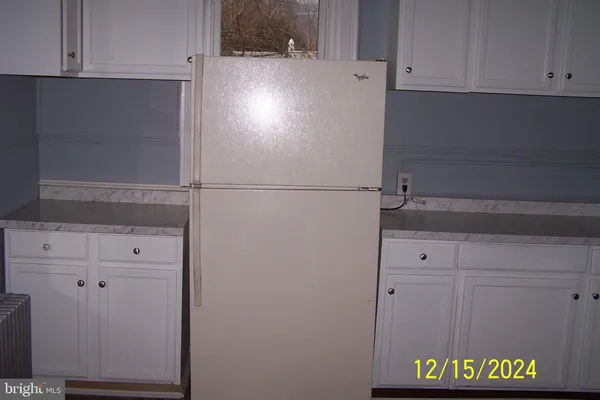 a white refrigerator freezer sitting inside of a kitchen