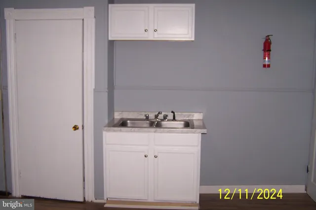 a utility room with sink dryer and washer