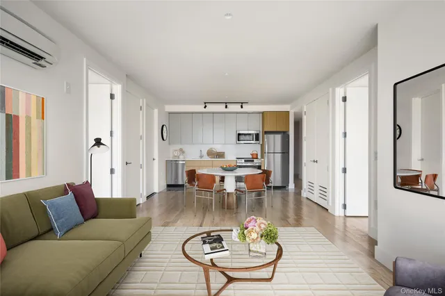a living room with furniture kitchen and a table